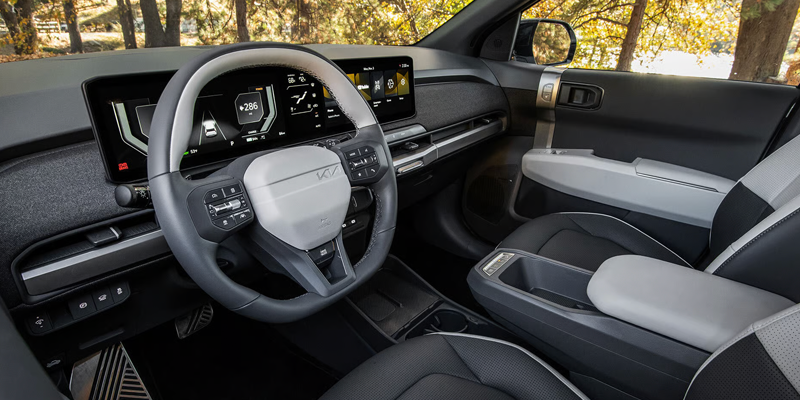 2027 Kia EV3 interior featuring steering wheel and digital displays