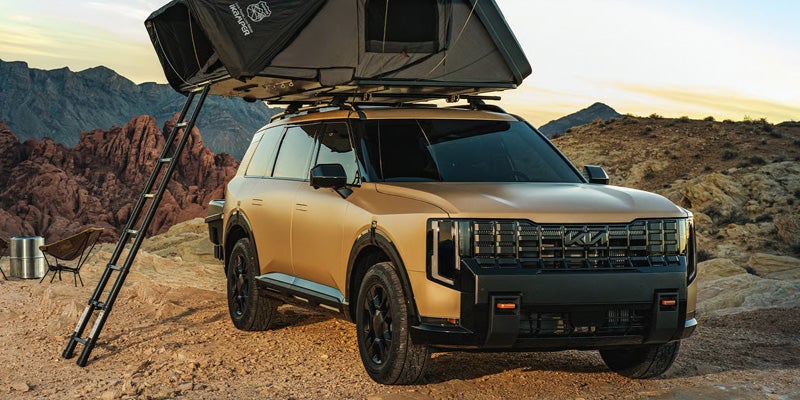 2027 Kia Telluride SUV with rooftop tent on rocky terrain